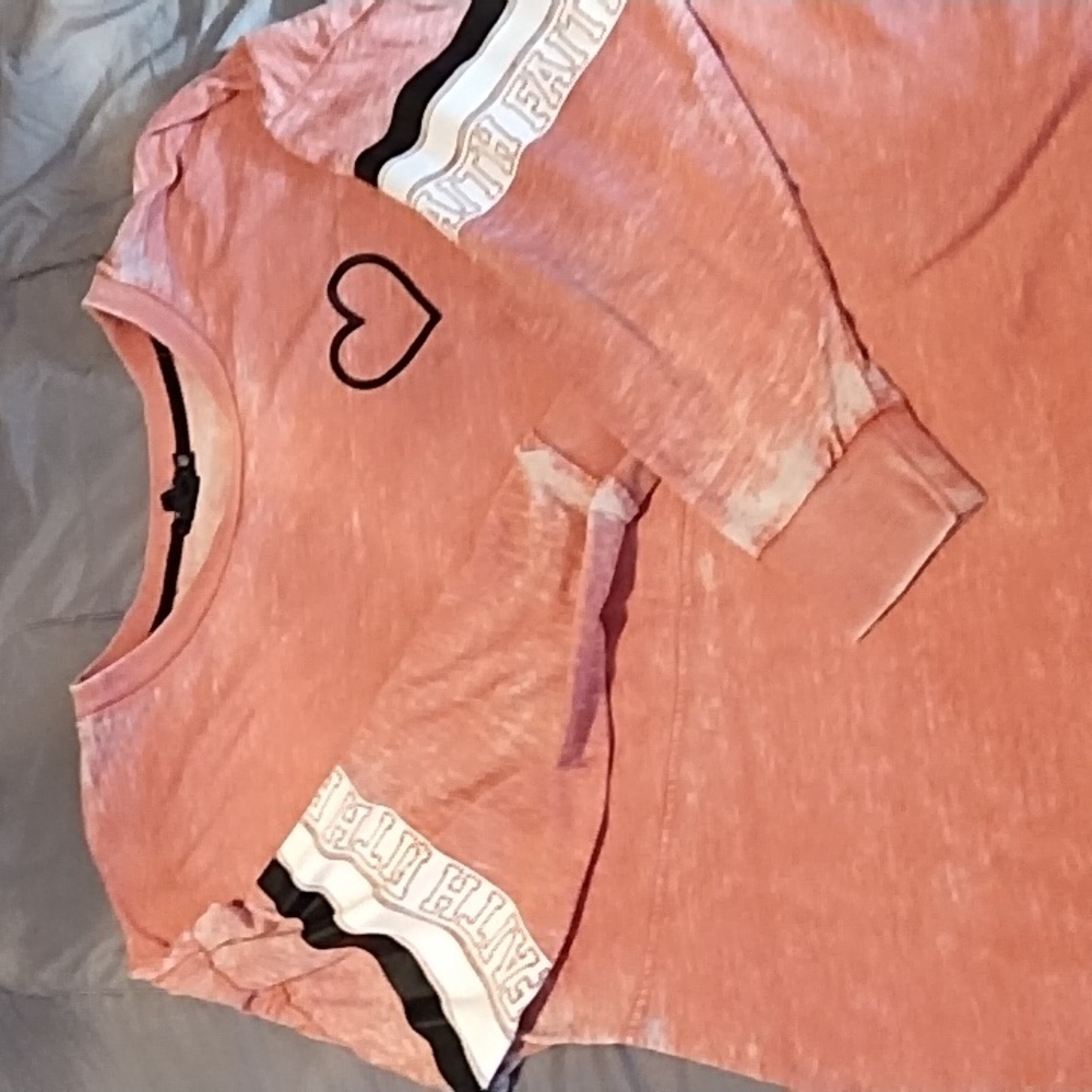 A pink/salmon colored long sleeve shirt